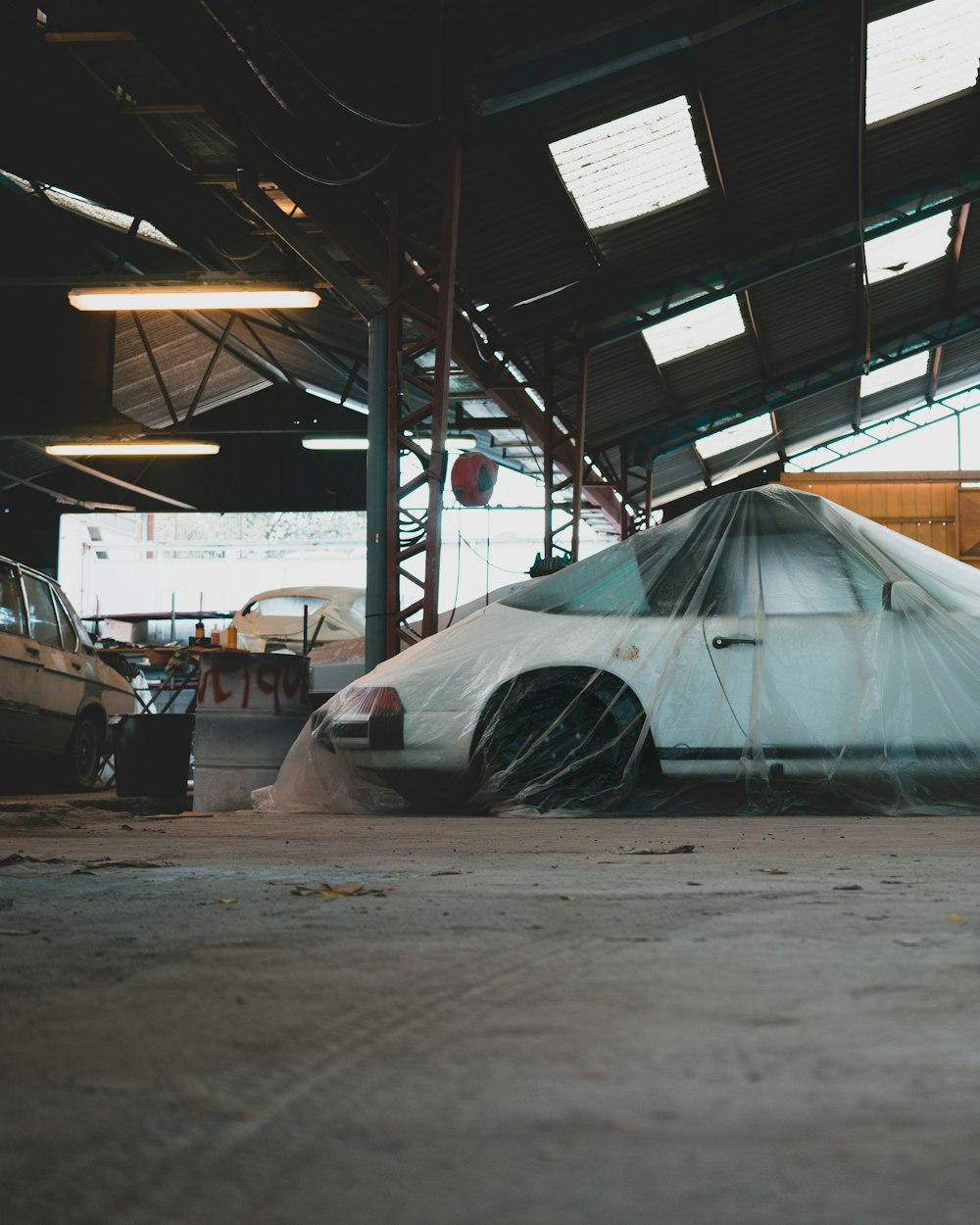 a car covered in a tarp in a garage