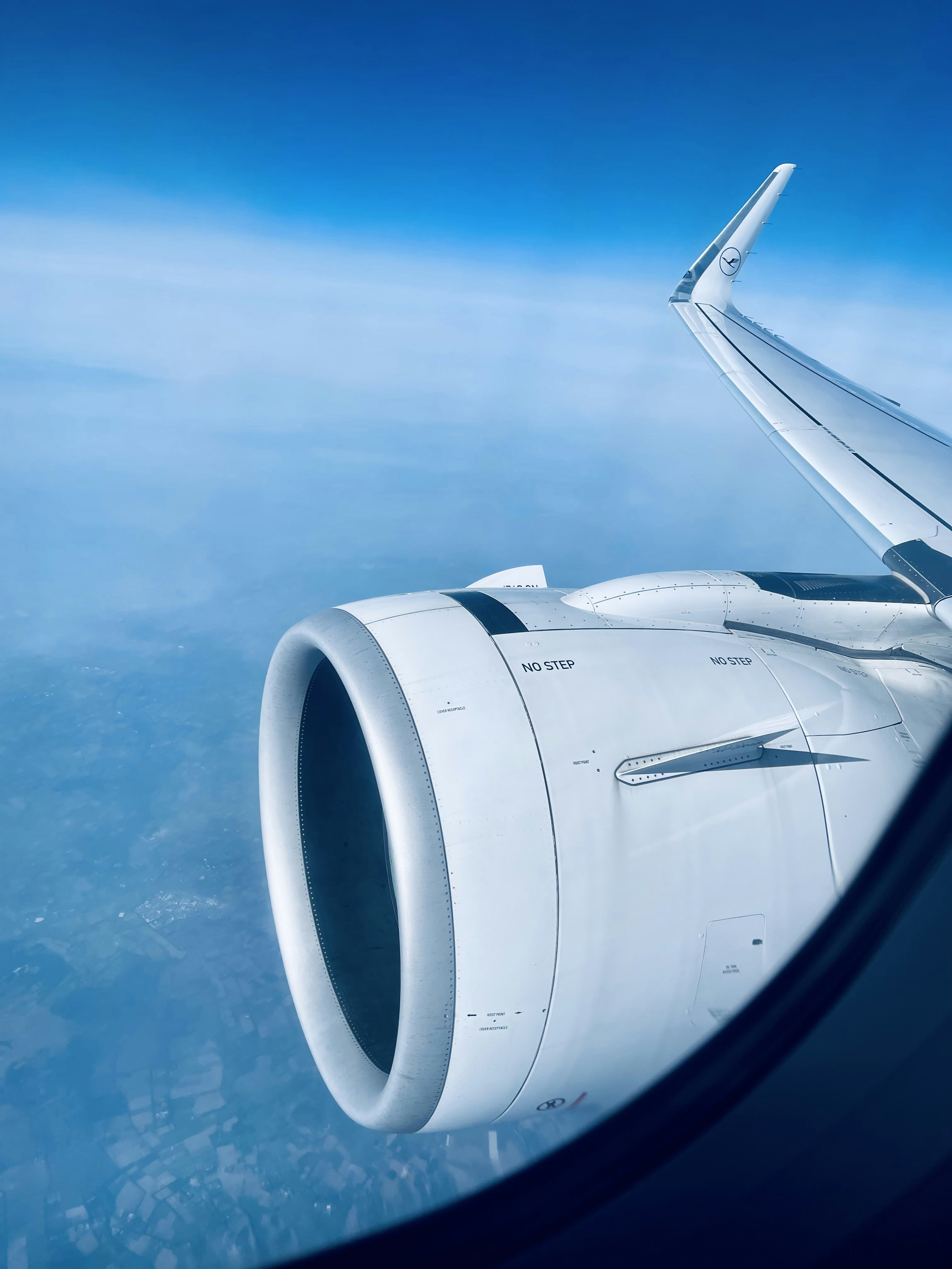 a view of the wing of an airplane in the sky