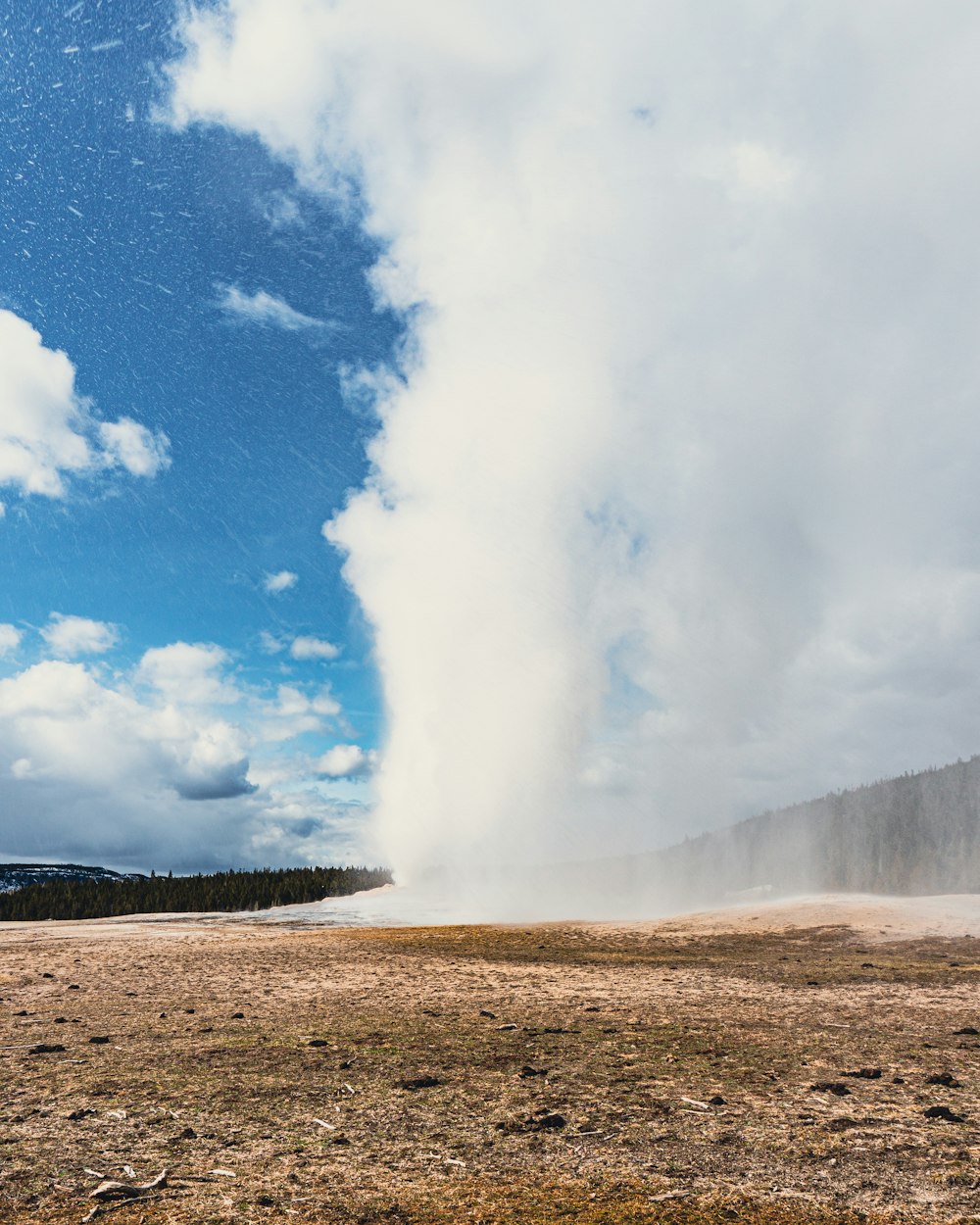 a large geyser spewing water into the sky