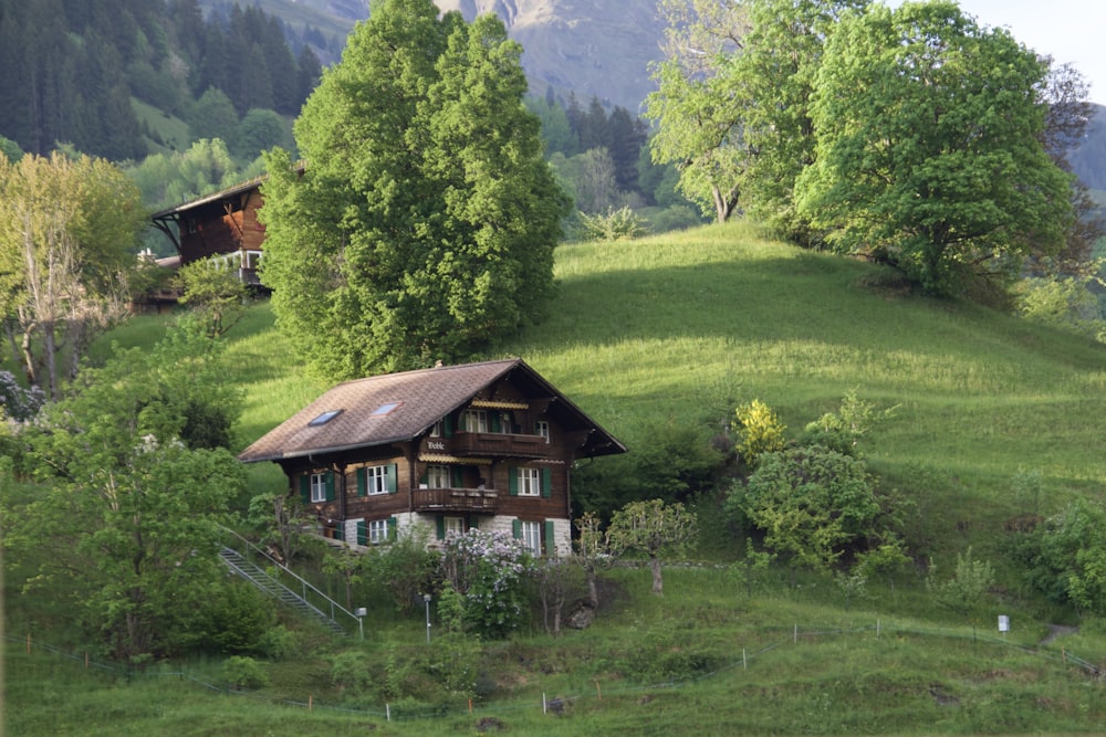 a house sitting on top of a lush green hillside