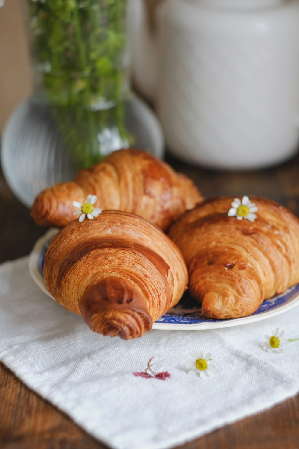 three croissants on a plate on a table