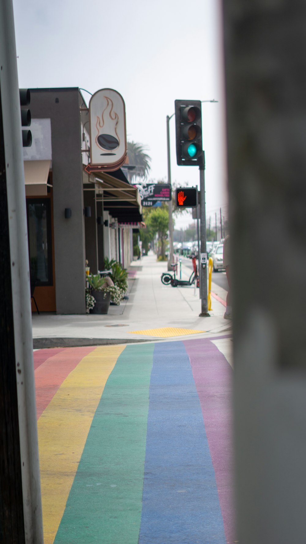 a rainbow painted street with a traffic light