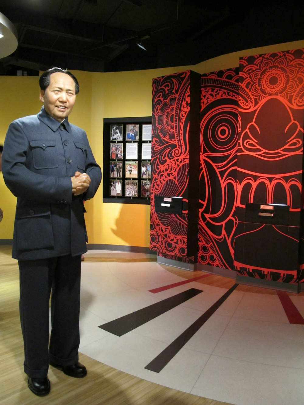 a man standing in front of a red and black wall