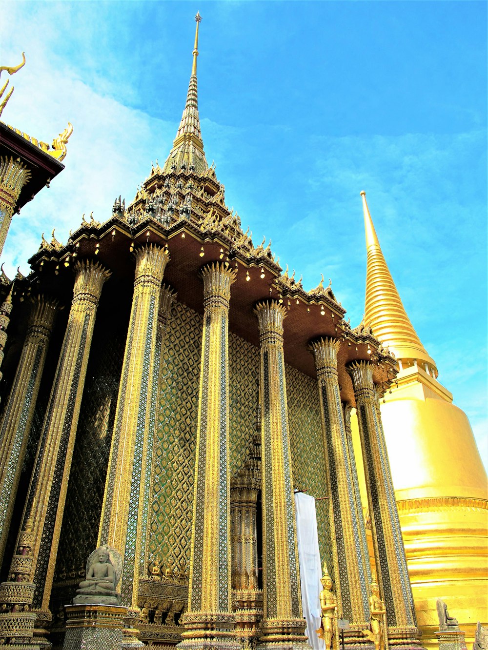 a large golden building with a clock on it's side