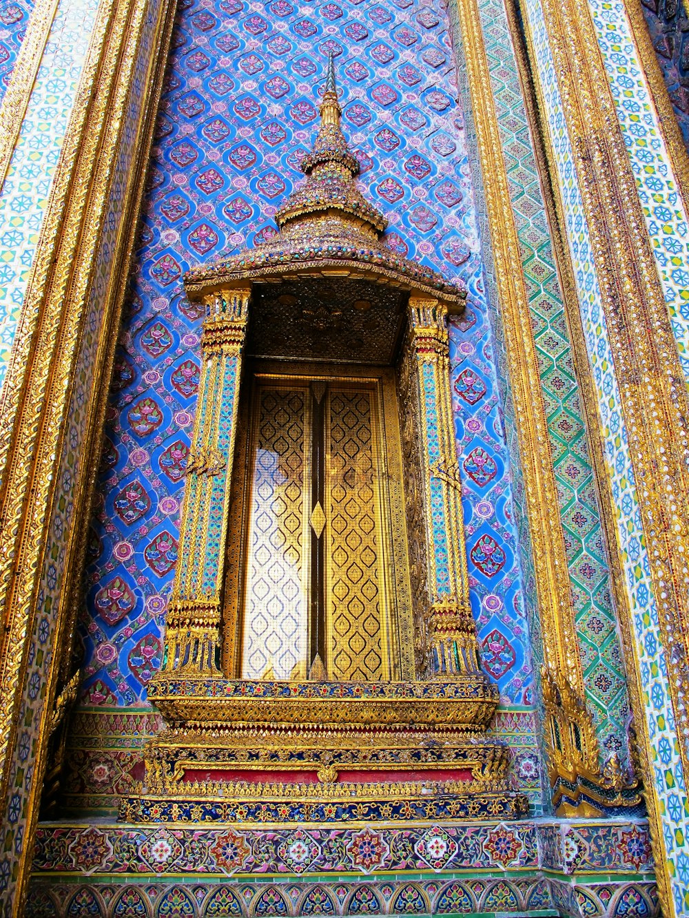 a gold and blue building with a large window