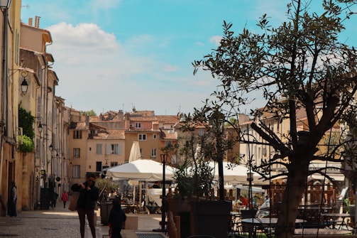 a couple of people that are walking down a street