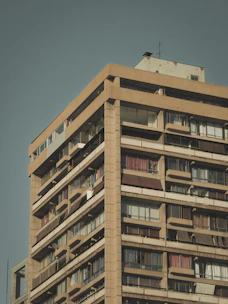 a tall building with balconies and balconies on top