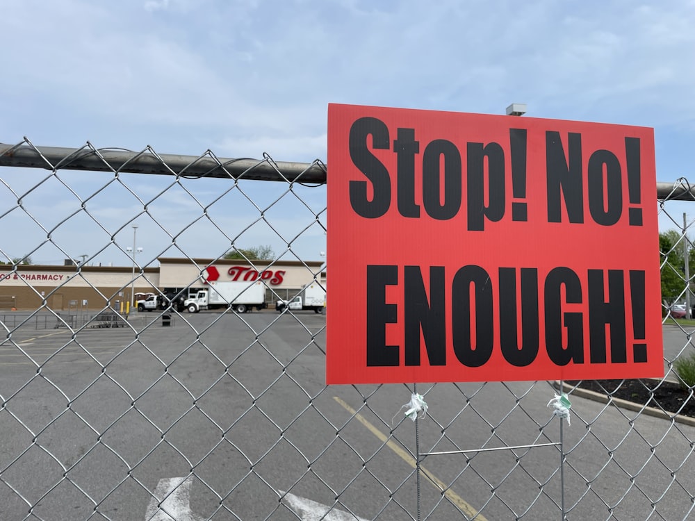 a red sign that says stop no enough