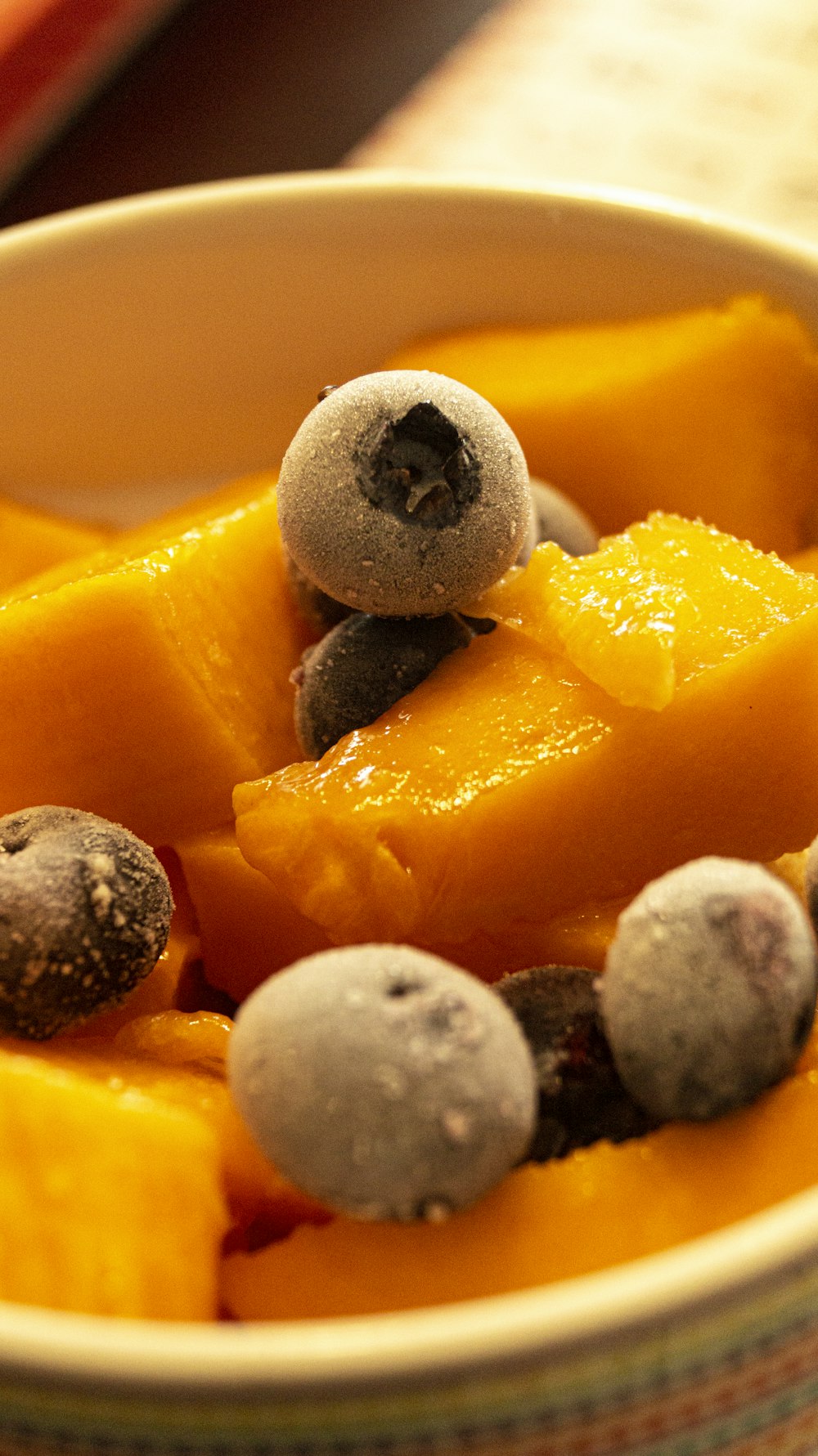 a bowl of fruit with blueberries and oranges