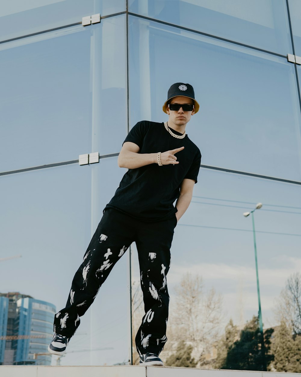 a man standing on a skateboard in front of a building