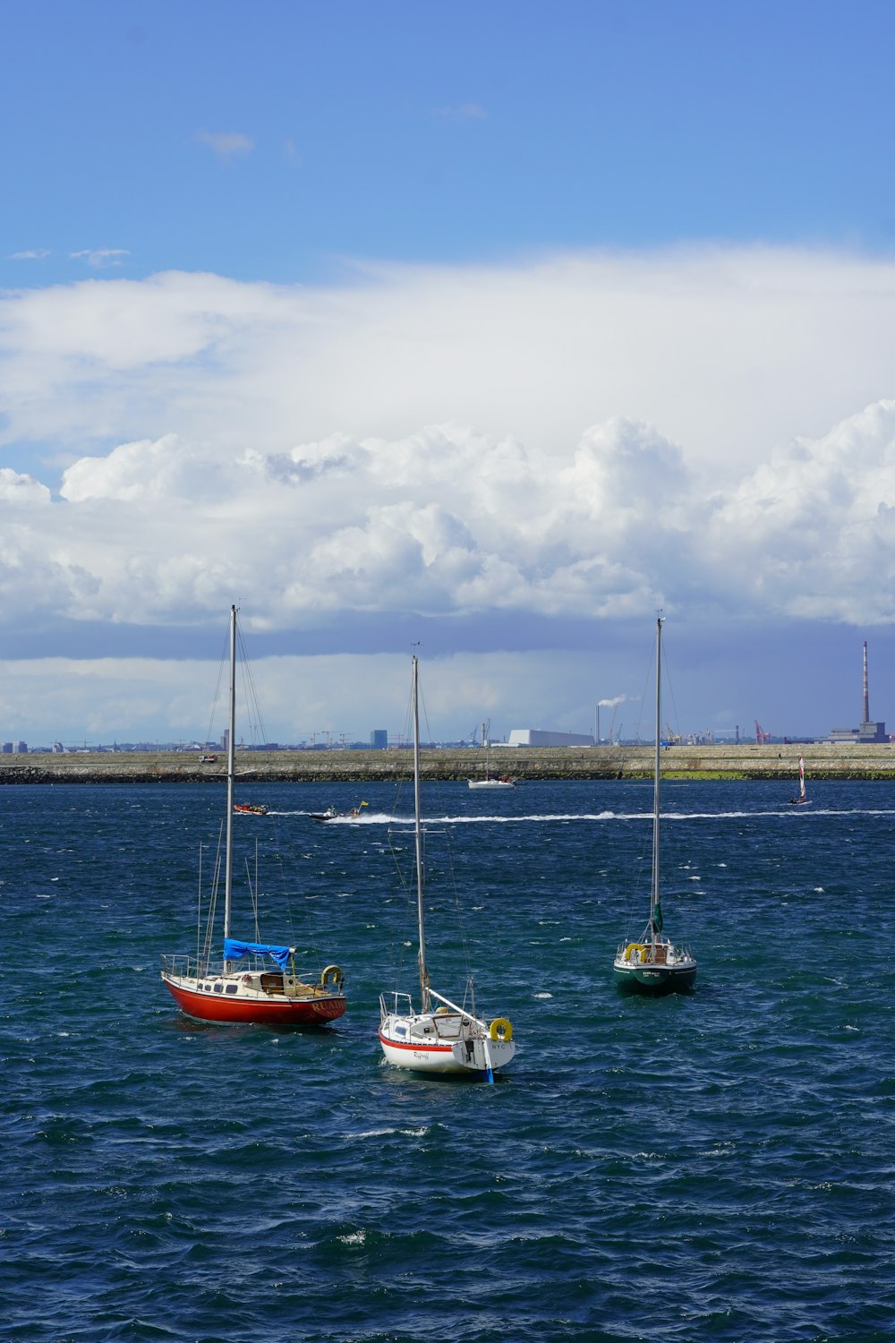 a group of boats floating on top of a body of water