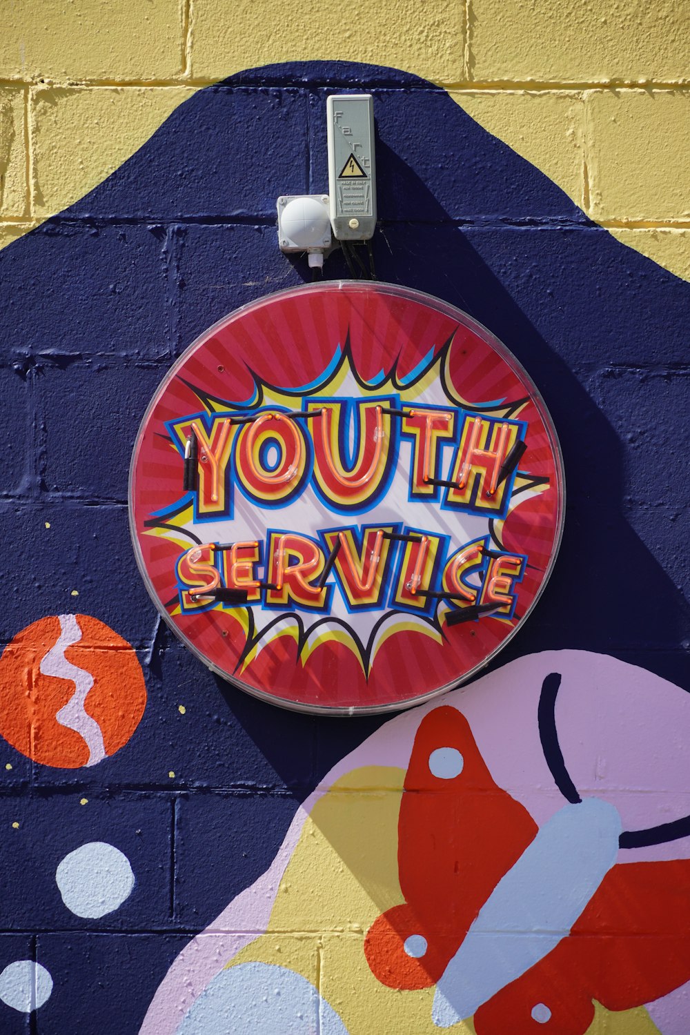 a sign on the side of a building that says youth service