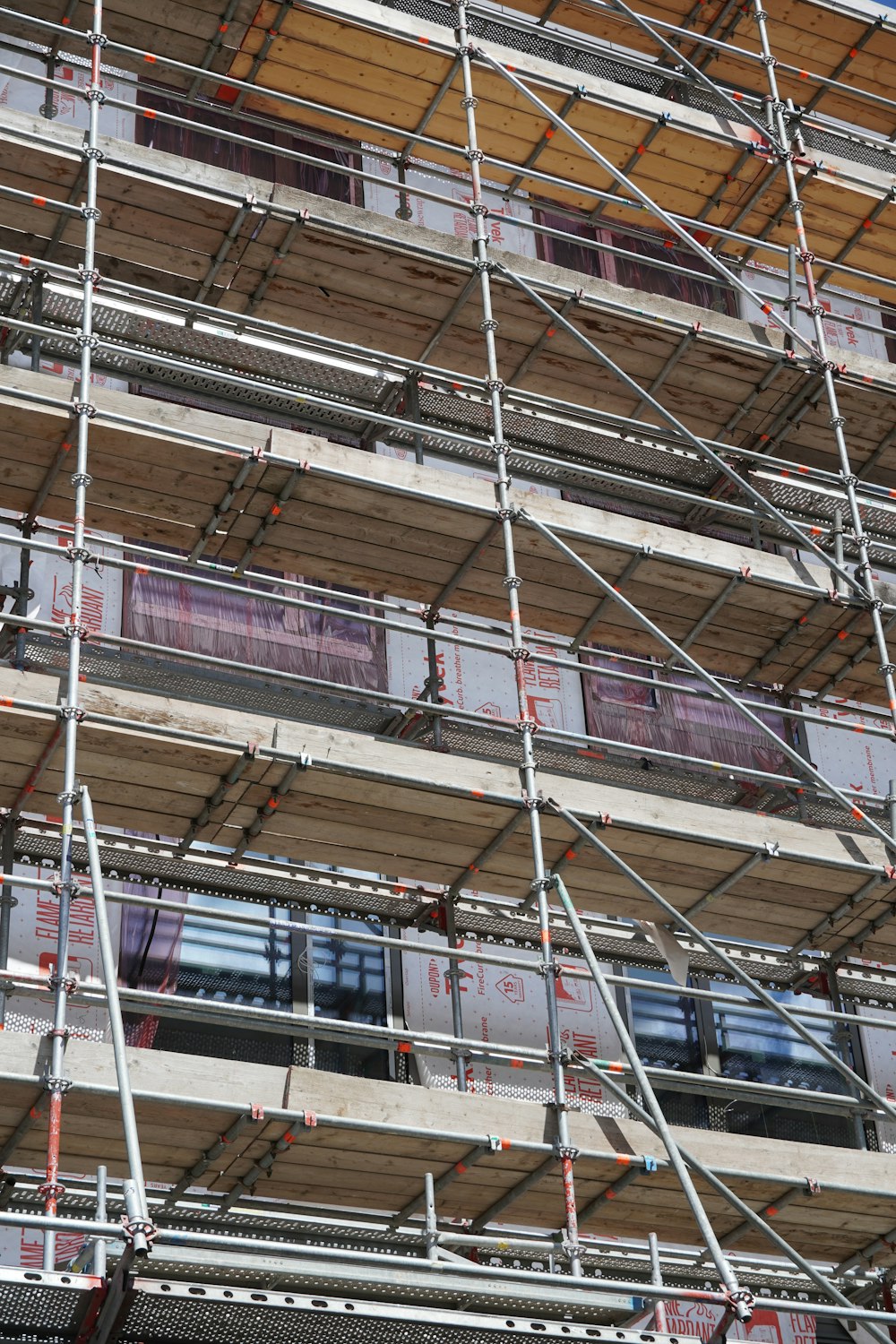 a tall building with scaffolding around the windows