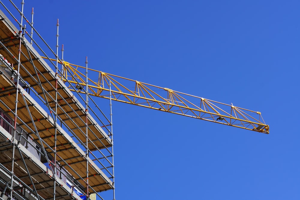 a crane is on top of a building under construction