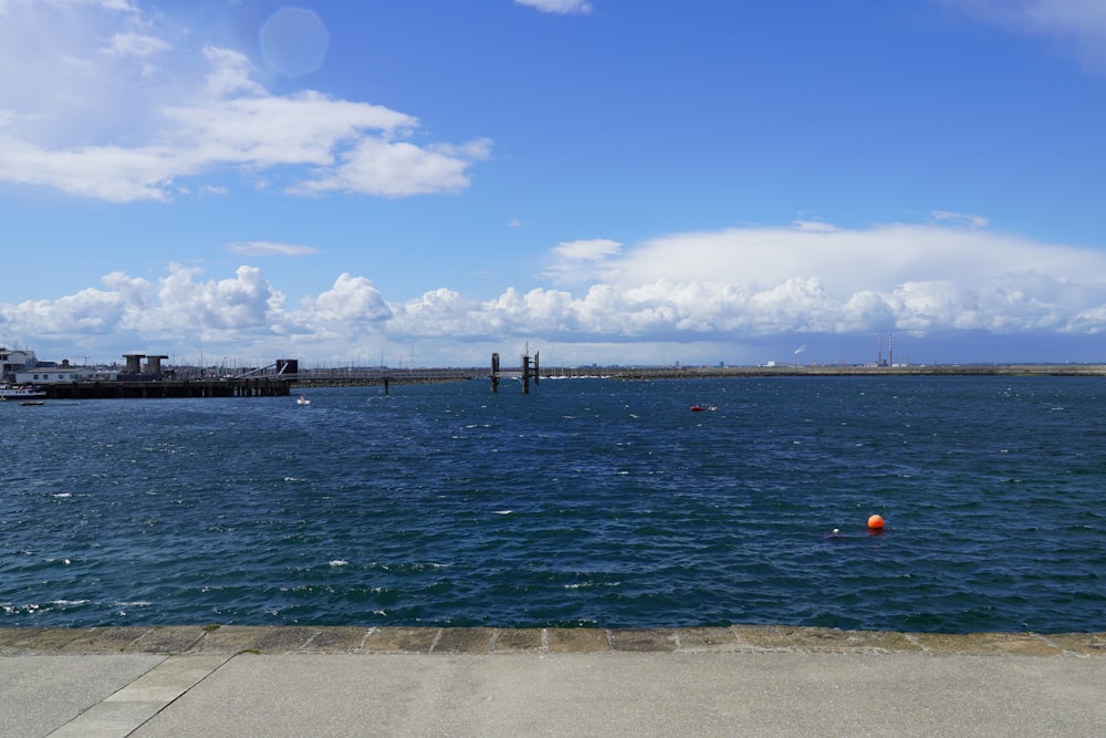 a body of water with a bridge in the background