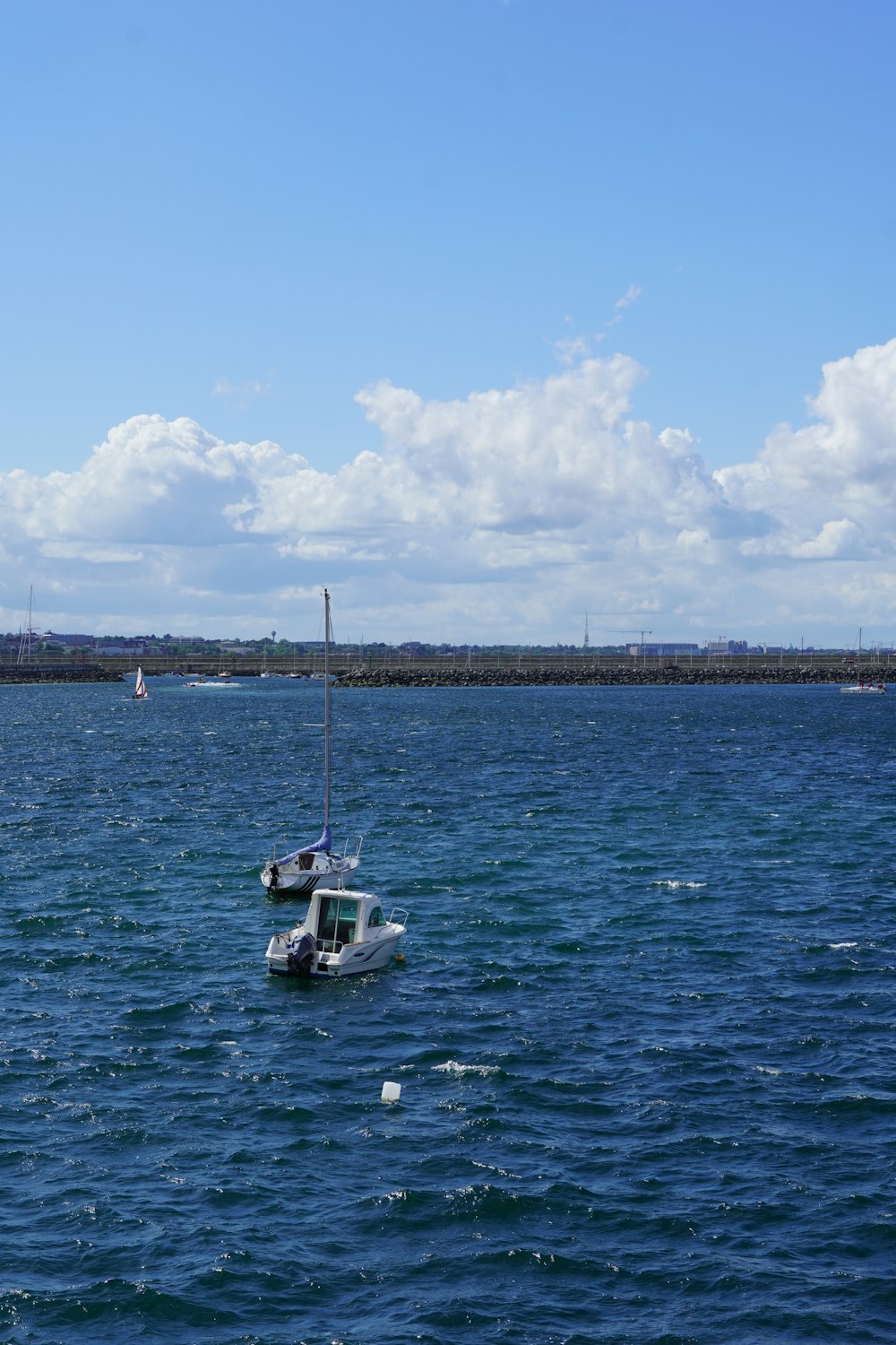 a small boat floating on top of a large body of water