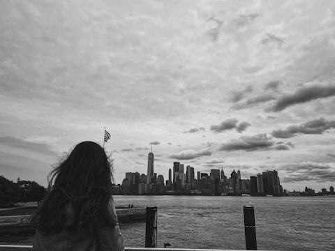 Portrait of a transgender American outdoors with vibrant cityscape behind.