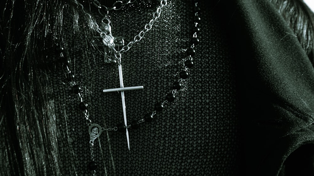 a man wearing a black shirt with a cross on it
