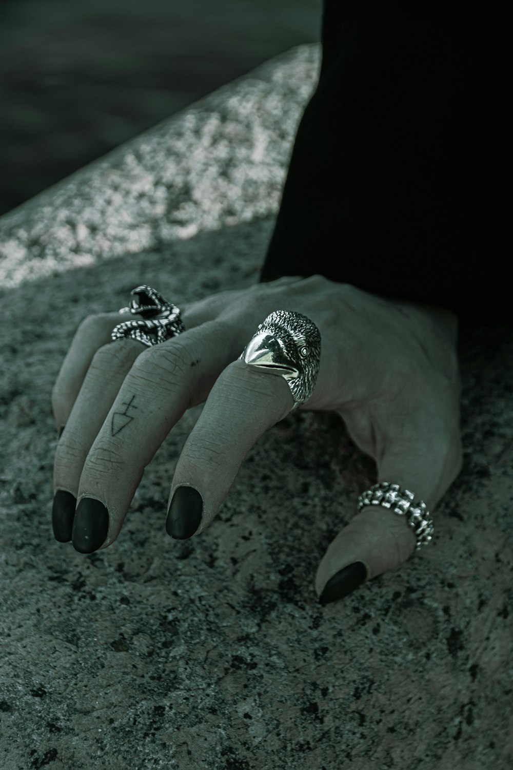 a woman's hand with two rings on it