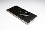 a close up of a cell phone on a white surface