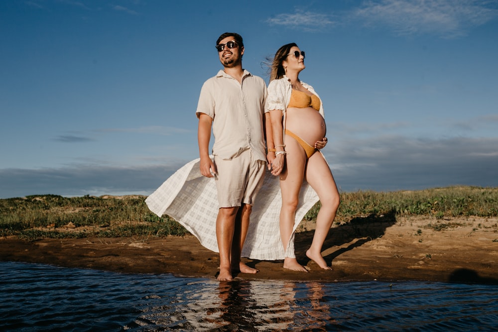 a man and a woman are standing in the water
