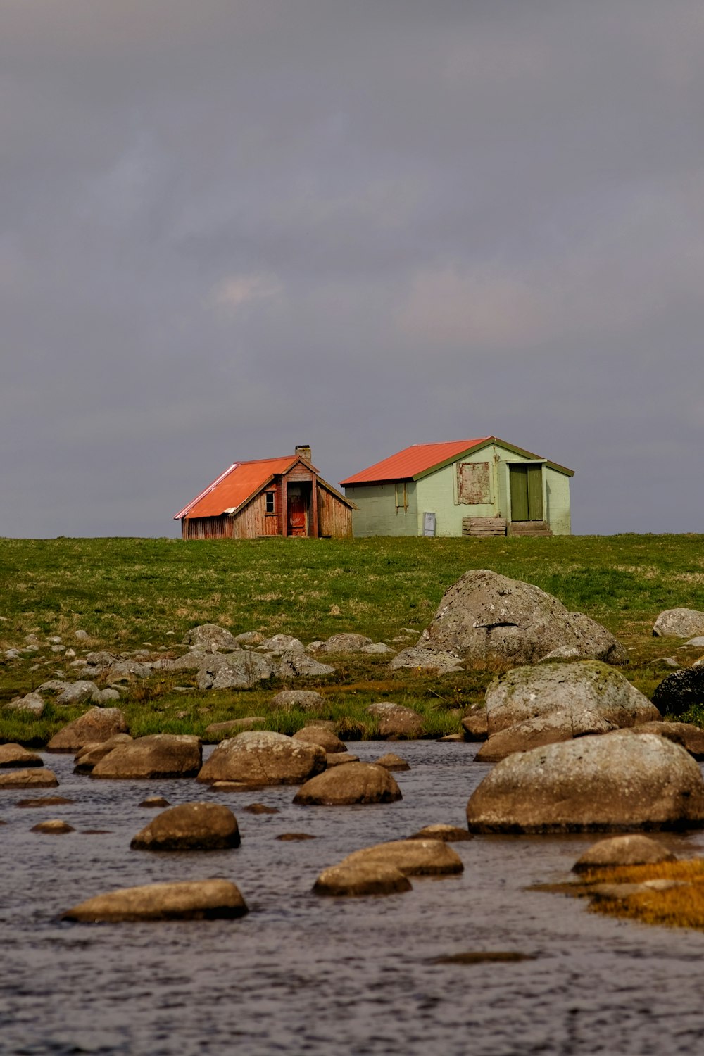 a house sitting on top of a lush green field