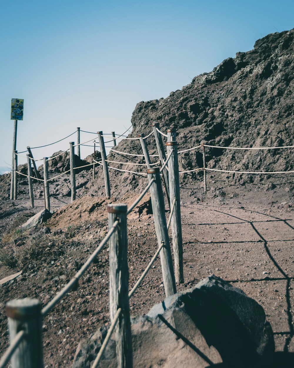 a wooden fence on the side of a hill