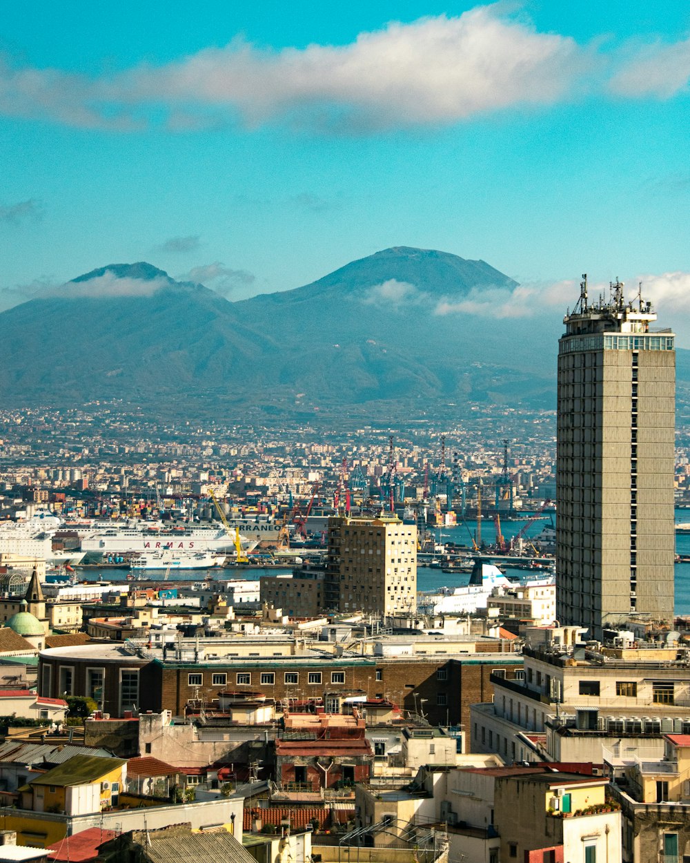 a view of a city with mountains in the background