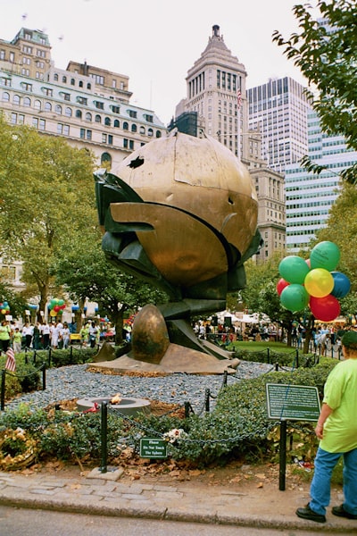 a man standing in front of a large fish statue