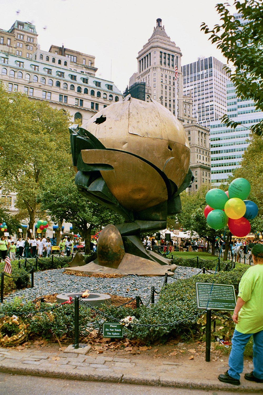 a man standing in front of a large fish statue