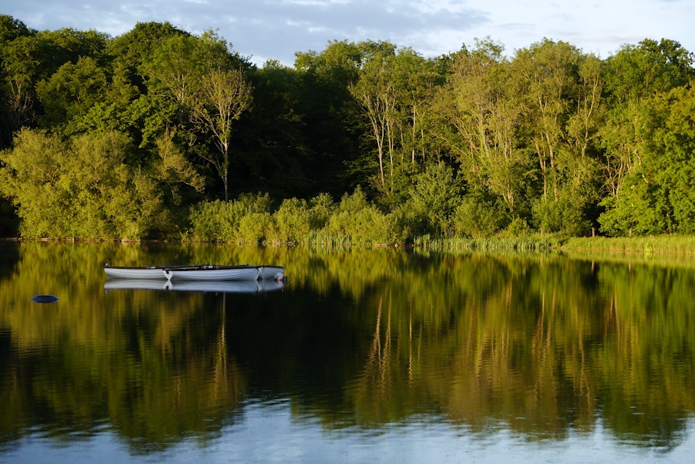 a small boat floating on top of a lake