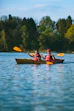 two people in a kayak paddling on a lake