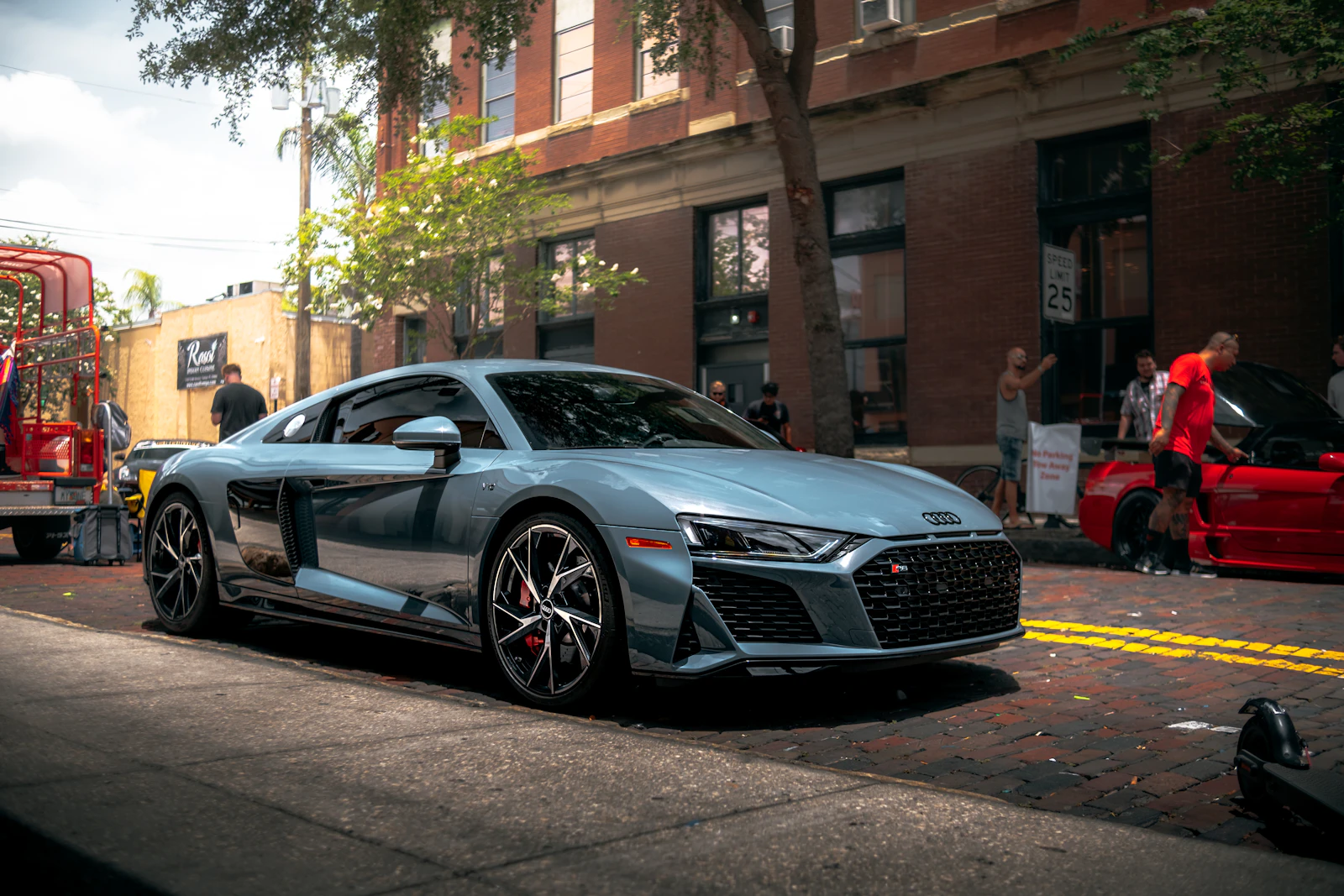 Gray Audi R8 parked on a brick street