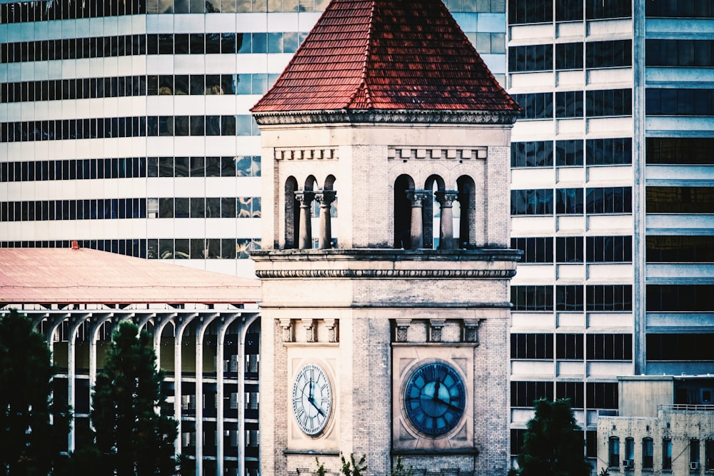 a clock tower with a red roof in a city