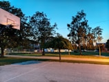 Evening view of a lit basketball court ready for a friendly match.