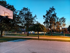 Evening view of a lit basketball court ready for a friendly match.
