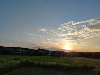 Sunset view over the peaceful countryside surrounding the rural house.