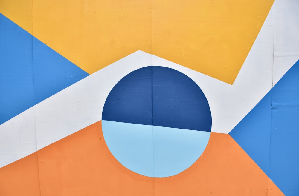 a close up of a colorful wall with a blue circle
