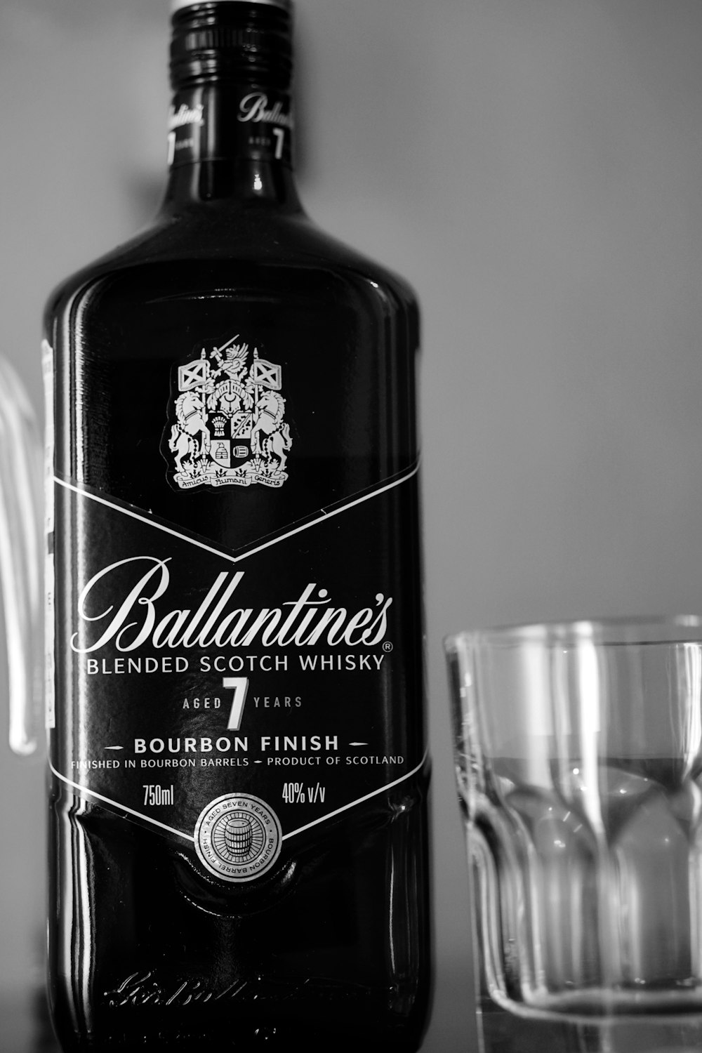 a bottle of ballantine's blended scotch whisky next to a shot glass