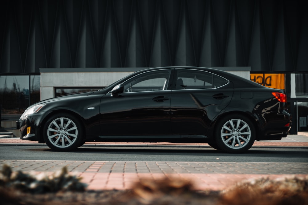 a black car parked in front of a building