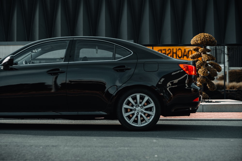 a black car parked on the side of the road