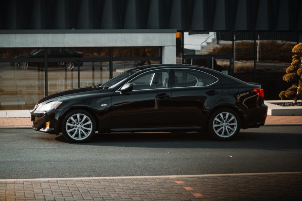 a black car parked in front of a building