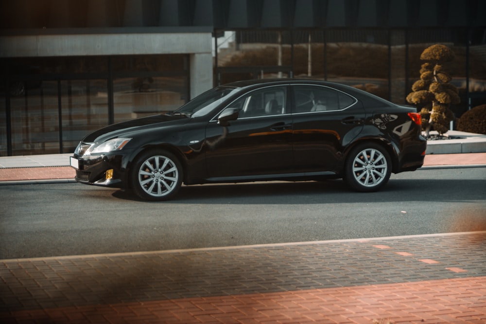 a black car parked on the side of the road