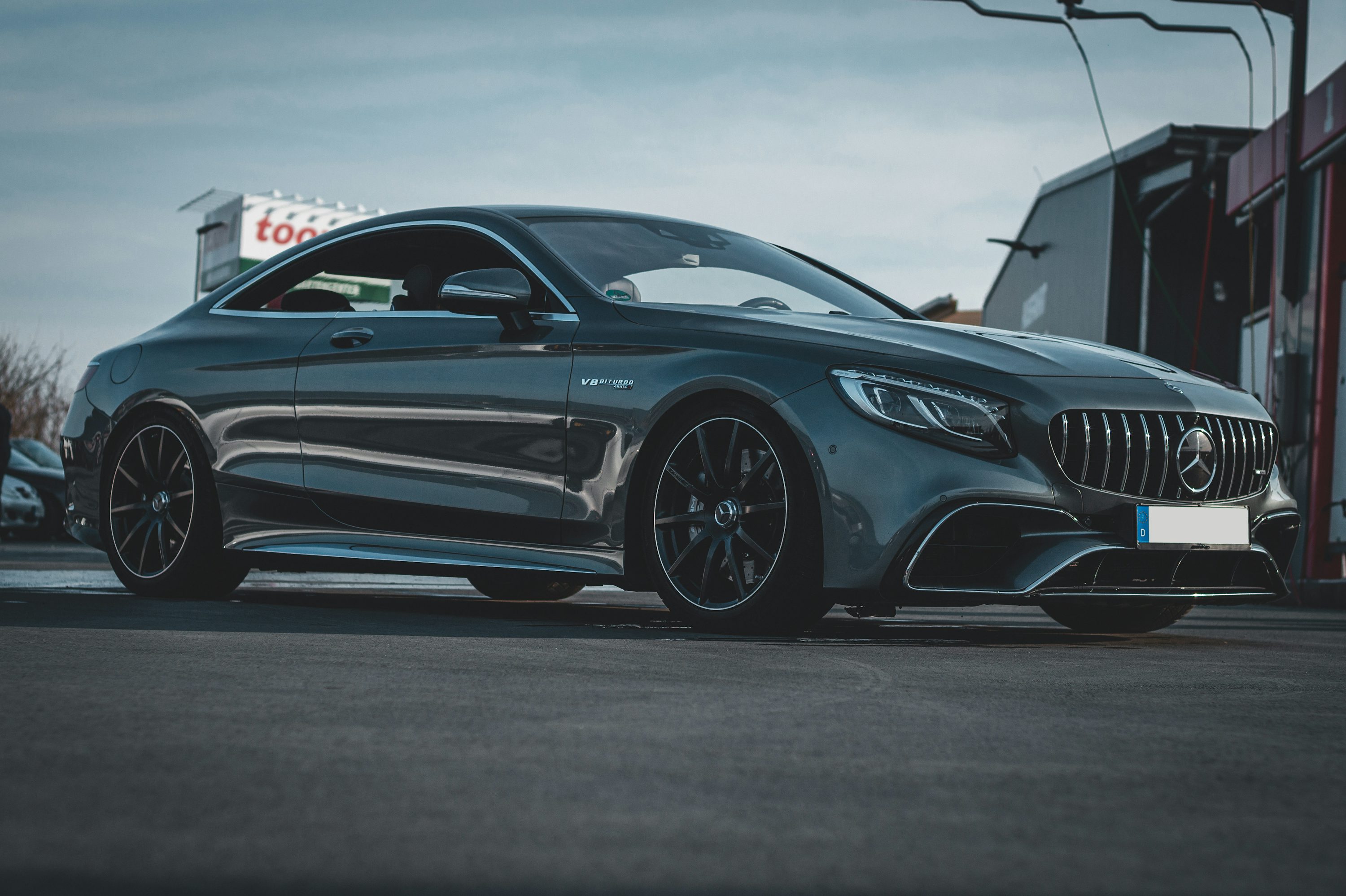 a grey car parked in front of a building