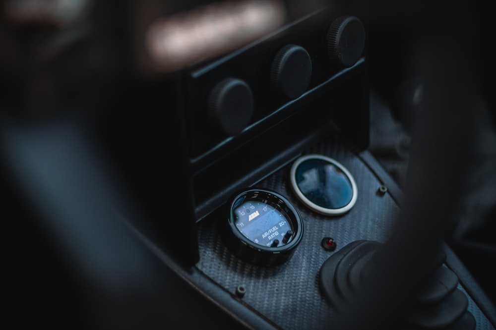 a close up of a car dashboard with a gauge