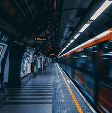 a train traveling through a train station next to a platform