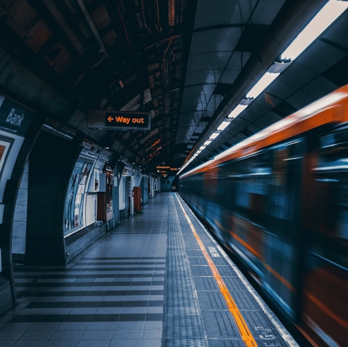 a train traveling through a train station next to a platform