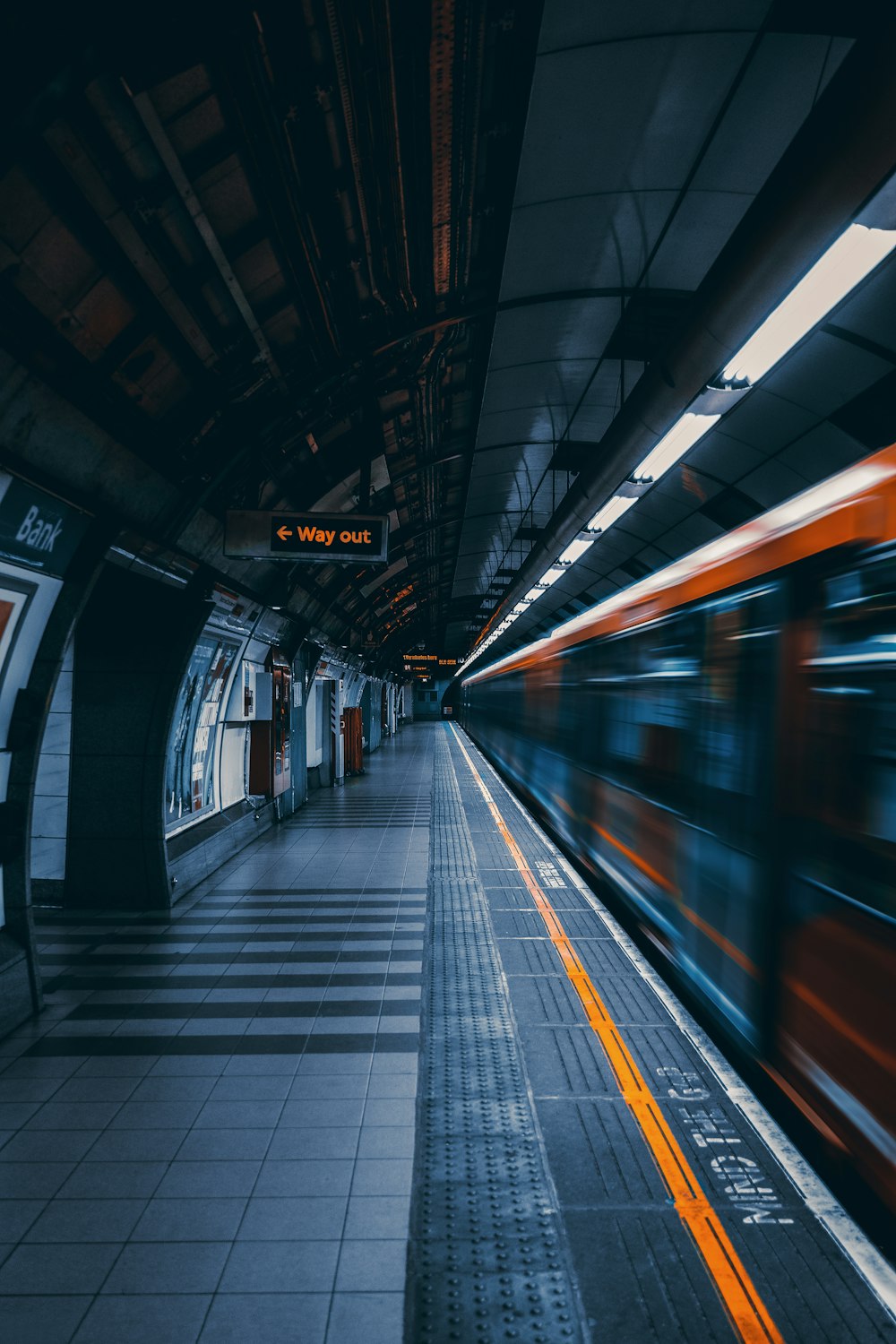 a train traveling through a train station next to a platform