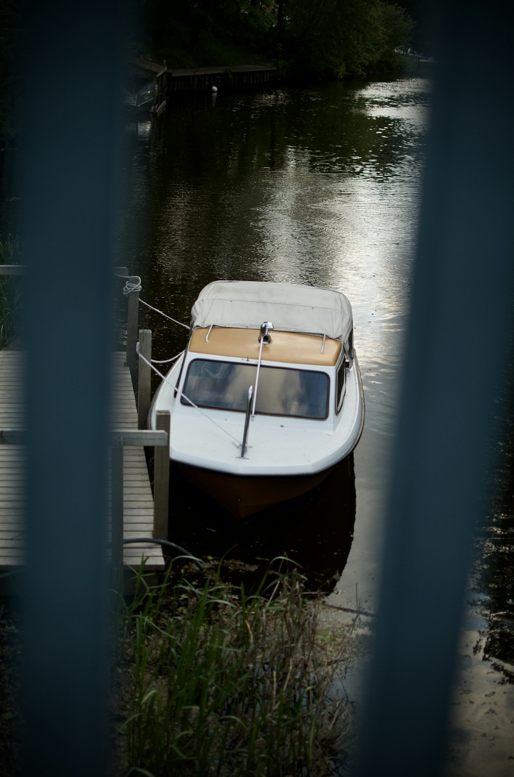 a small boat tied to a dock in a body of water