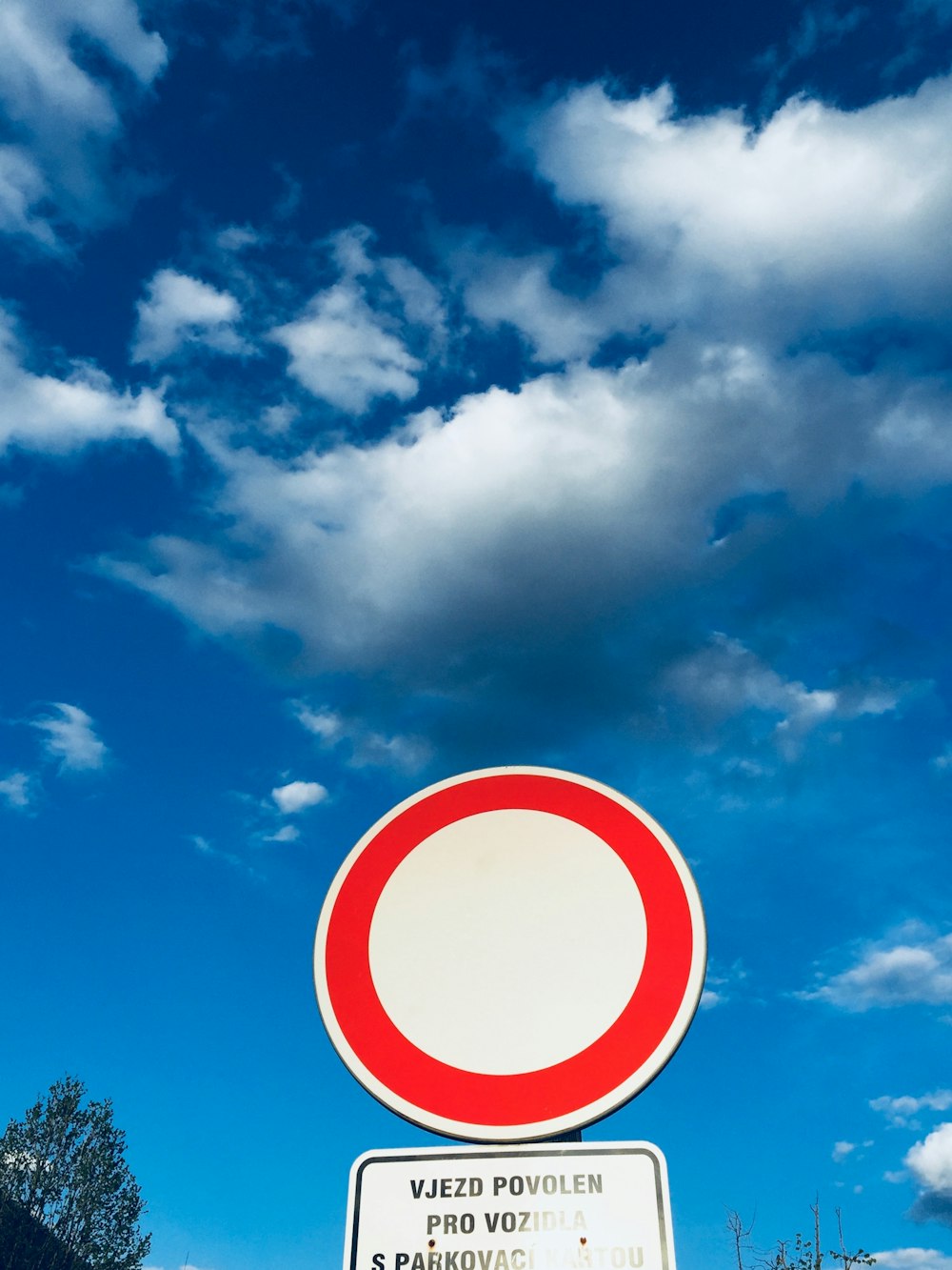 a red and white street sign sitting on the side of a road